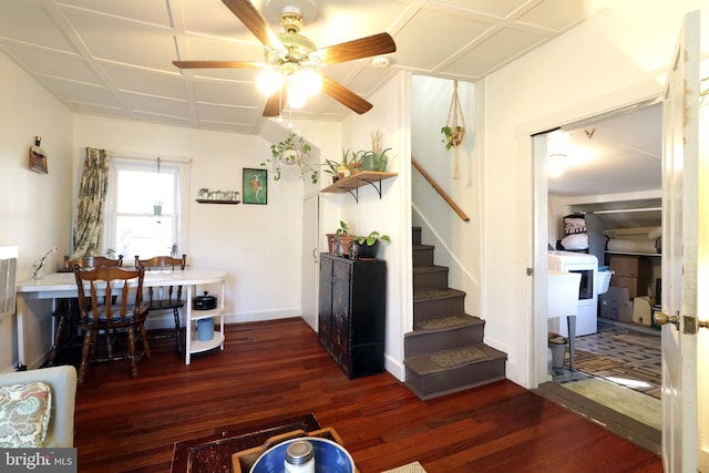 interior space with ceiling fan, baseboards, stairs, wood finished floors, and washer / clothes dryer