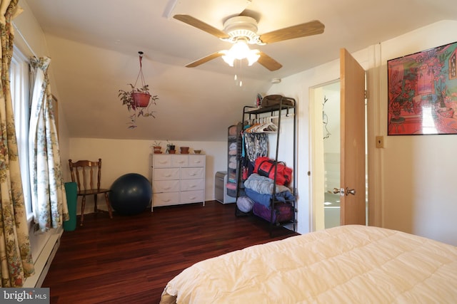 bedroom with lofted ceiling, baseboard heating, wood finished floors, and a ceiling fan