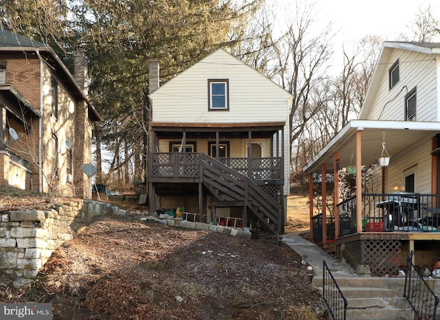 back of house with stairway and covered porch