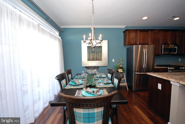 dining space featuring crown molding, a notable chandelier, visible vents, and dark wood-type flooring