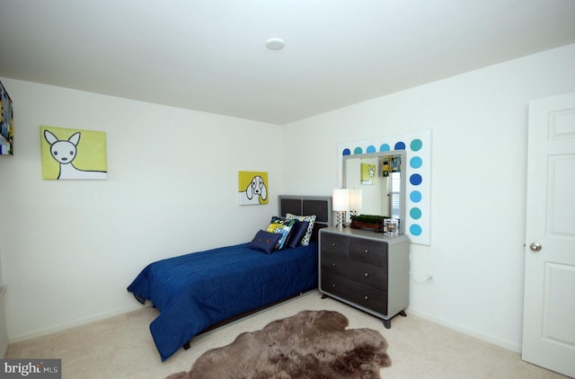 bedroom featuring light colored carpet and baseboards