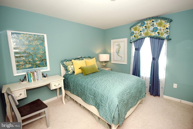 carpeted bedroom with baseboards