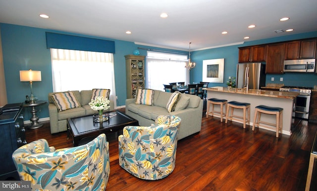 living room featuring recessed lighting, baseboards, dark wood-type flooring, and a chandelier