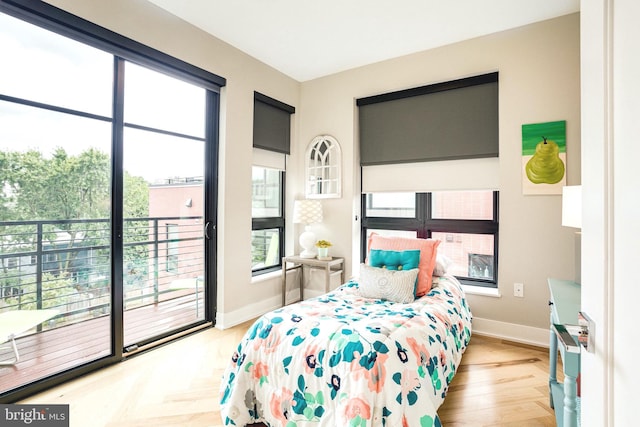 1345 K St SE Unit 406, Washington, DC 20003 - bedroom featuring access to exterior, multiple windows, and baseboards