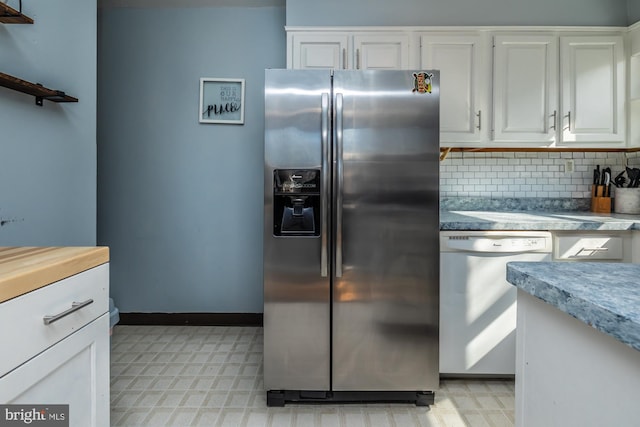 kitchen featuring light floors, white cabinetry, stainless steel refrigerator with ice dispenser, dishwasher, and tasteful backsplash