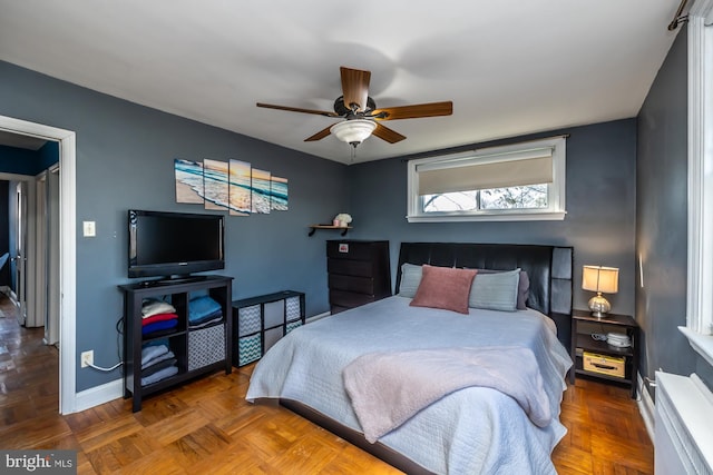 bedroom featuring a ceiling fan and baseboards