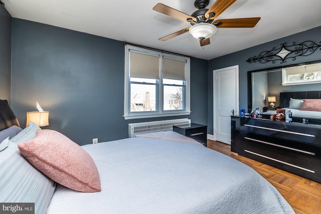 bedroom with radiator and a ceiling fan