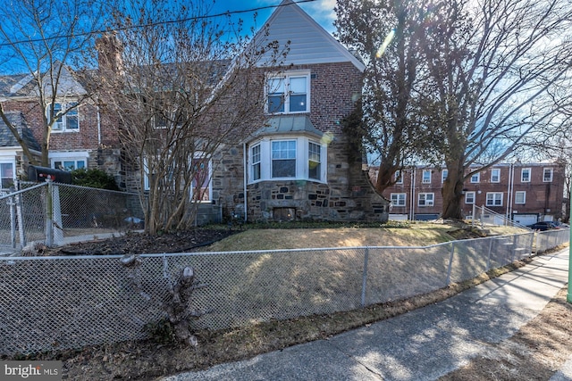 view of front facade featuring a fenced front yard and stone siding