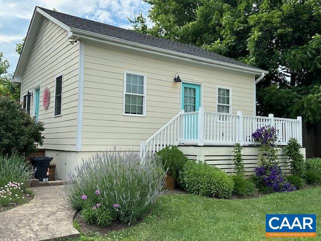 rear view of house featuring a wooden deck