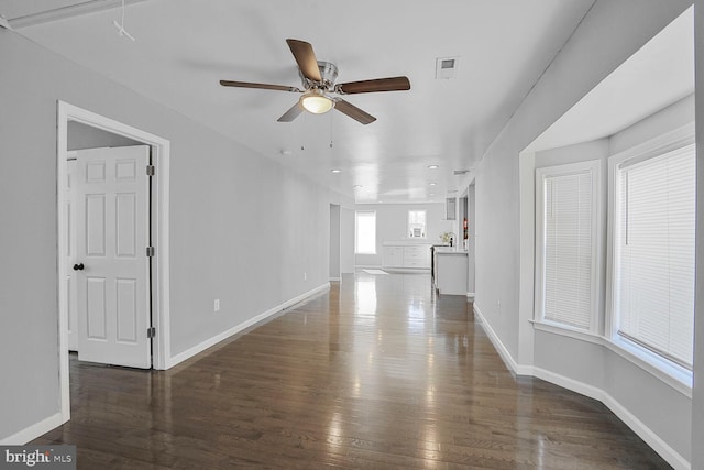 unfurnished living room featuring visible vents, a ceiling fan, wood finished floors, recessed lighting, and baseboards