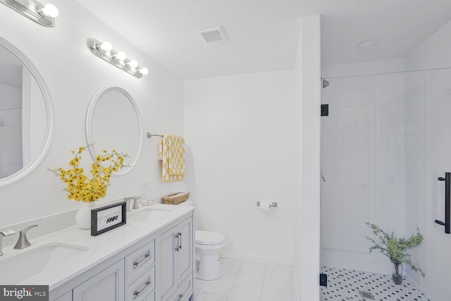 bathroom with a sink, visible vents, tiled shower, and toilet