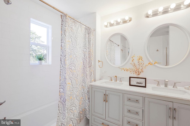 full bath with double vanity, shower / bath combo, and a sink