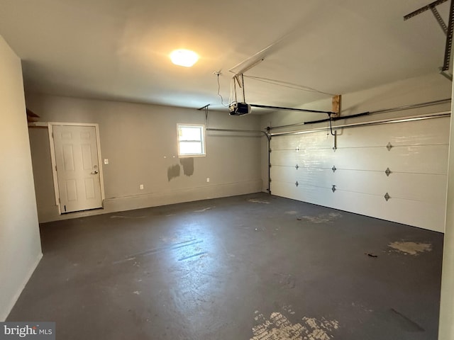 garage with a garage door opener and baseboards