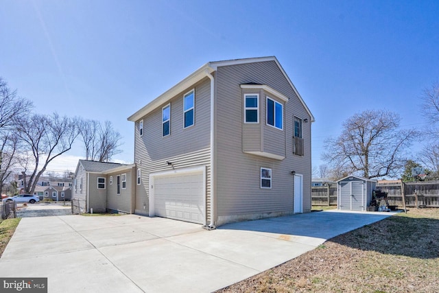 view of side of home with fence, driveway, an attached garage, an outdoor structure, and a storage unit