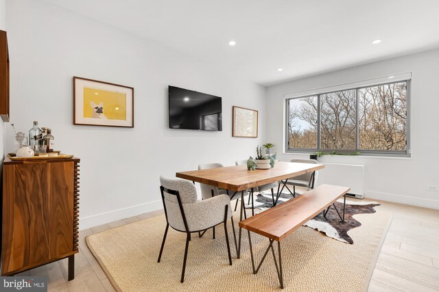 dining room featuring recessed lighting, baseboards, and light wood finished floors