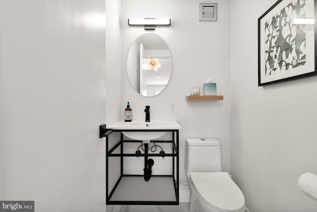 bathroom with toilet and a sink