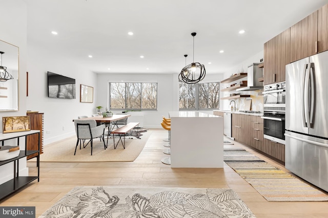 kitchen with a kitchen island, open shelves, light wood-style flooring, light countertops, and appliances with stainless steel finishes