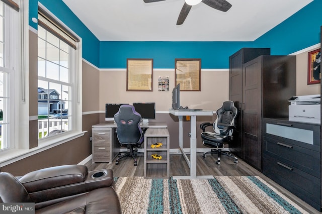 office featuring a ceiling fan, baseboards, and wood finished floors