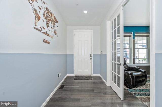 interior space with visible vents, baseboards, wood finished floors, and french doors