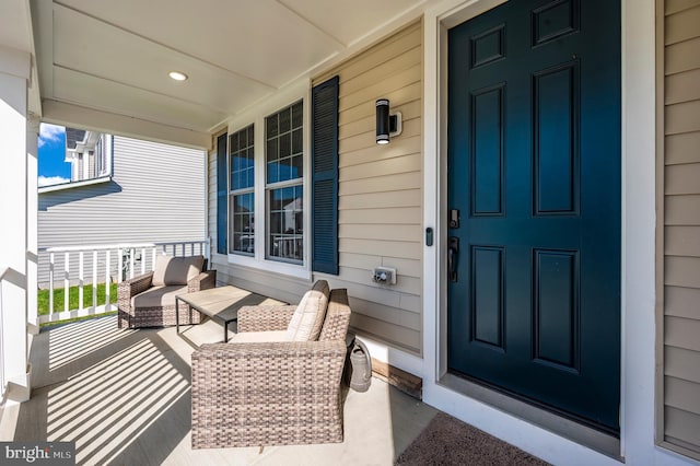 view of exterior entry featuring covered porch