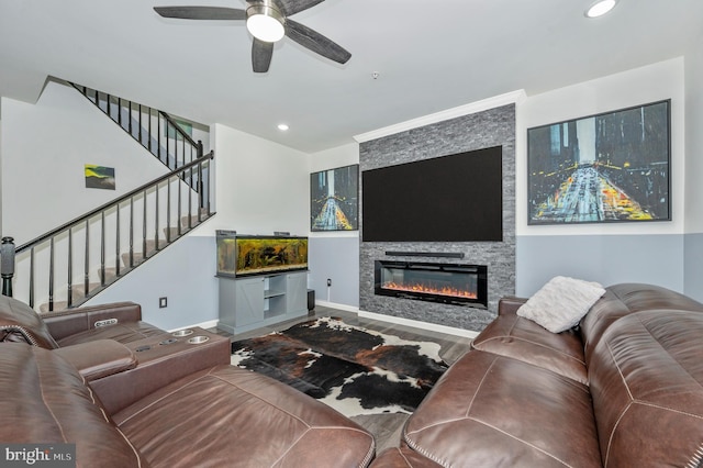 living room with a ceiling fan, recessed lighting, stairway, a large fireplace, and baseboards