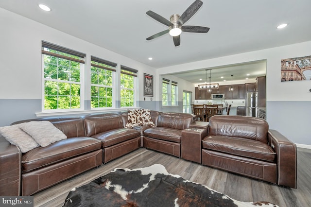 living area with recessed lighting, wood finished floors, and ceiling fan