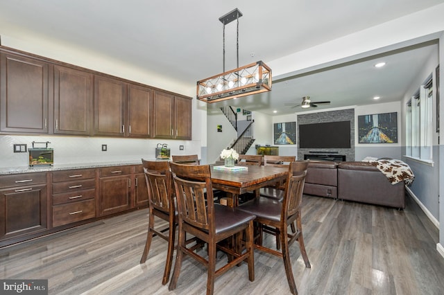 dining area featuring baseboards, stairway, light wood-type flooring, recessed lighting, and a ceiling fan