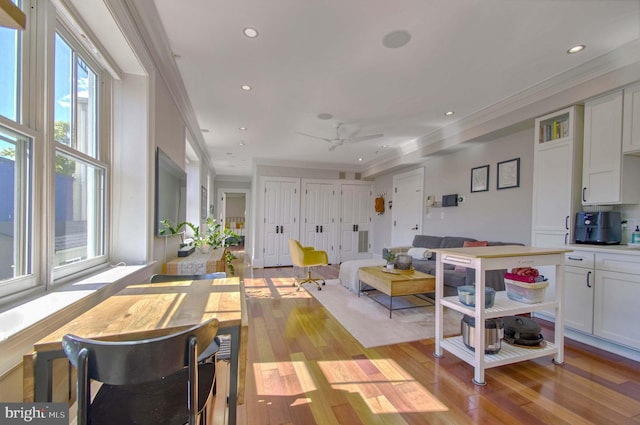 living room with light wood finished floors, recessed lighting, and crown molding