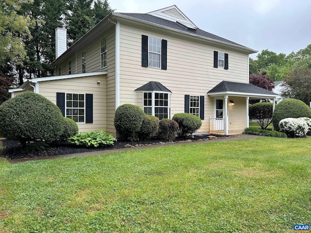 view of front of house featuring a front yard and a chimney