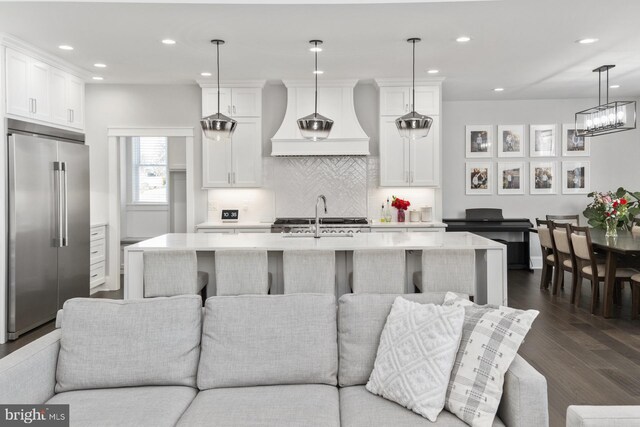 286 Claremont Ave, Harrisonburg, VA 22801 - kitchen featuring premium range hood, built in refrigerator, open floor plan, and light countertops