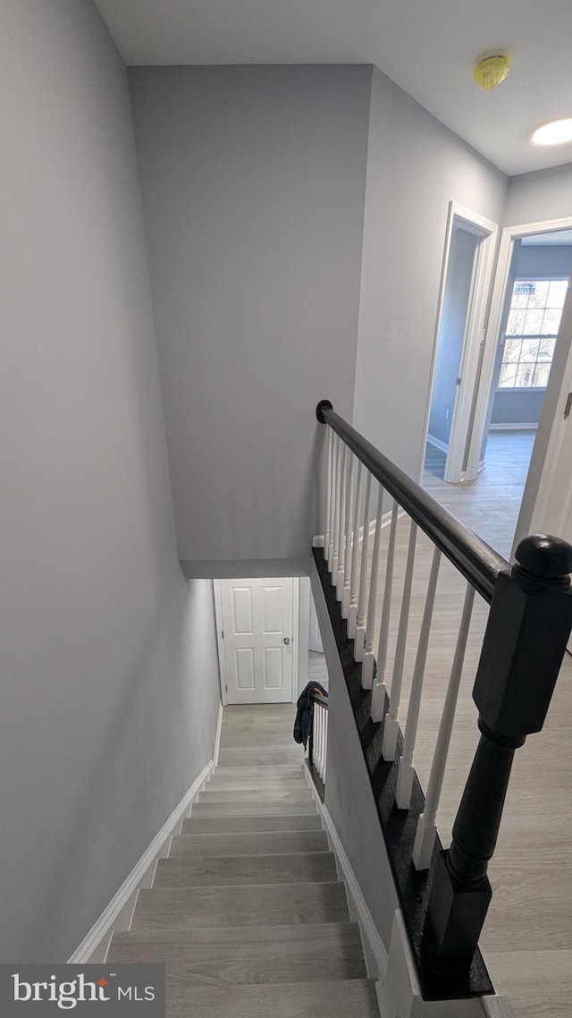 stairs with baseboards and wood finished floors