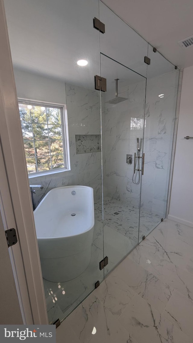 bathroom featuring a freestanding tub, visible vents, marble finish floor, and a marble finish shower