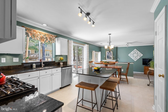 kitchen featuring a sink, dishwasher, ornamental molding, and white cabinets