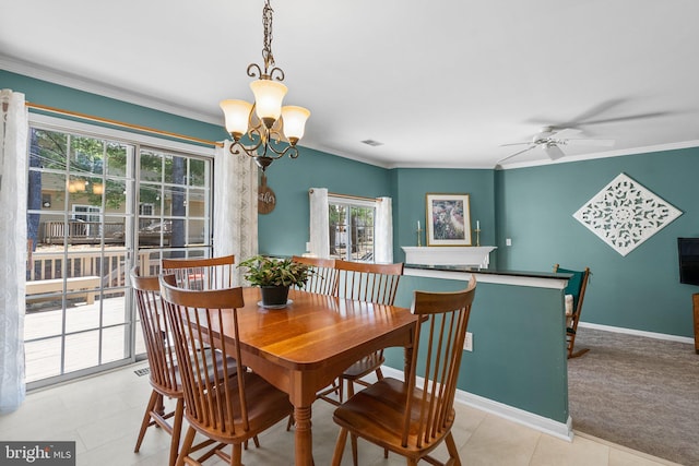 tiled dining space with visible vents, ornamental molding, ceiling fan with notable chandelier, carpet, and baseboards