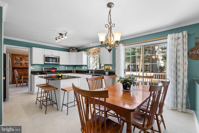 dining room featuring a chandelier and ornamental molding