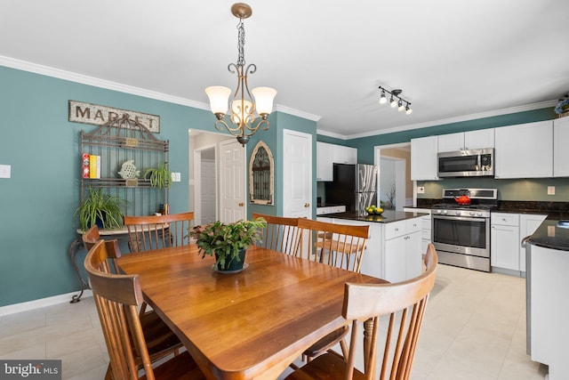 dining room with a chandelier, light tile patterned floors, crown molding, and baseboards