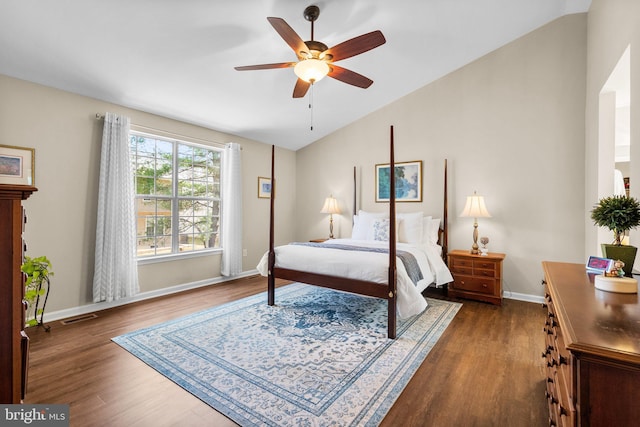 bedroom featuring visible vents, a ceiling fan, dark wood-style floors, baseboards, and lofted ceiling