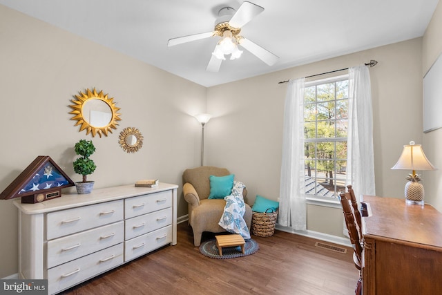 office space featuring ceiling fan, wood finished floors, visible vents, and baseboards