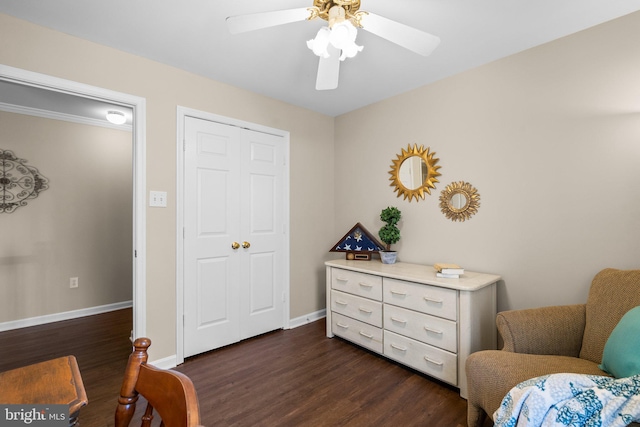 living area with dark wood-style floors, baseboards, and ceiling fan