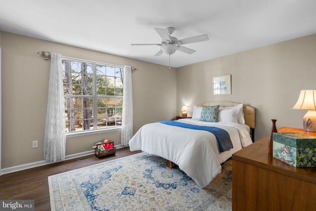 bedroom with a ceiling fan, visible vents, wood finished floors, and baseboards