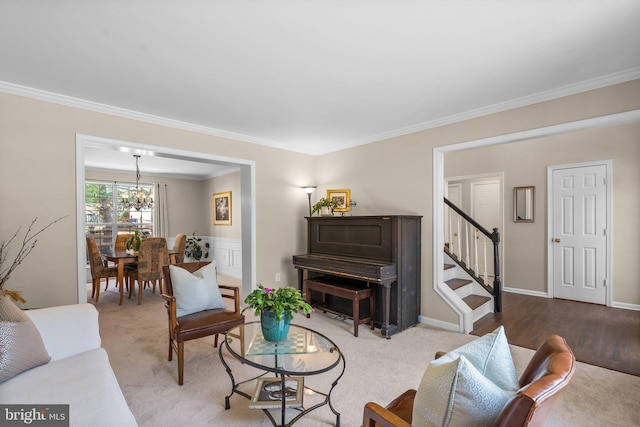 living area with stairway, baseboards, ornamental molding, a notable chandelier, and carpet flooring