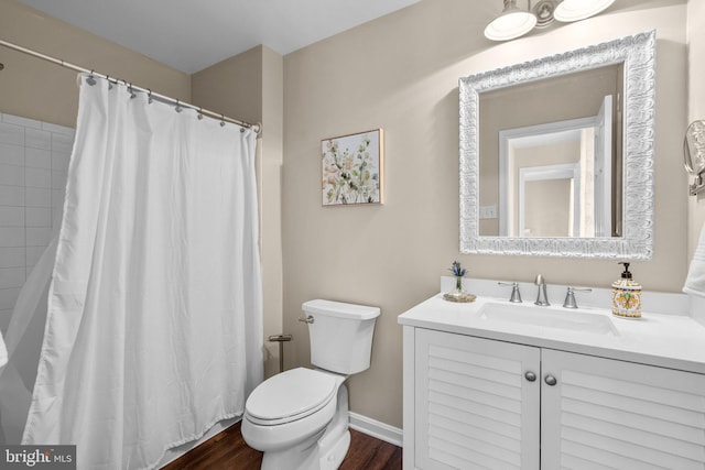 bathroom featuring curtained shower, baseboards, toilet, wood finished floors, and vanity