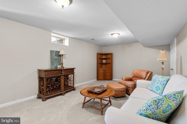 living room featuring carpet flooring, a textured ceiling, and baseboards