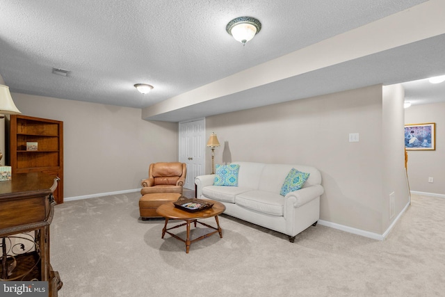 living room with carpet flooring, visible vents, a textured ceiling, and baseboards