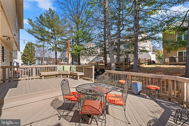 wooden terrace featuring outdoor dining space