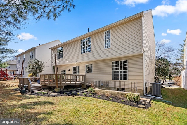 rear view of house featuring central air condition unit, a yard, and a deck