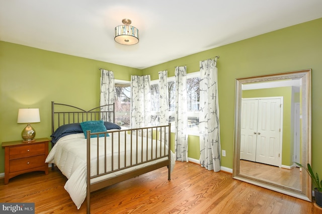 bedroom with baseboards and wood finished floors