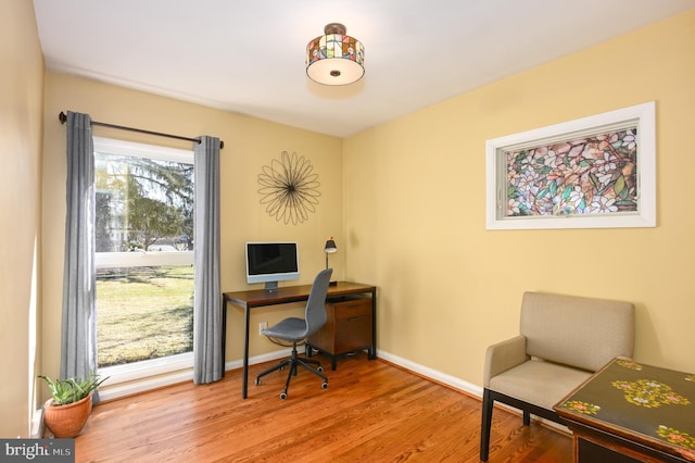 office featuring baseboards and wood finished floors