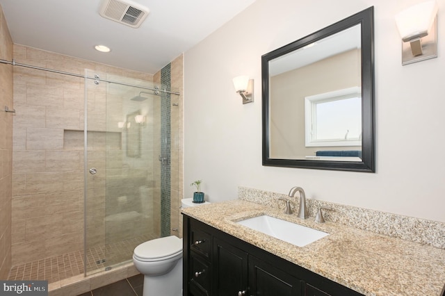 full bathroom featuring visible vents, toilet, a stall shower, tile patterned floors, and vanity