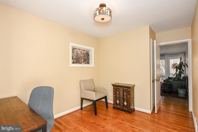 office space with baseboards and wood finished floors